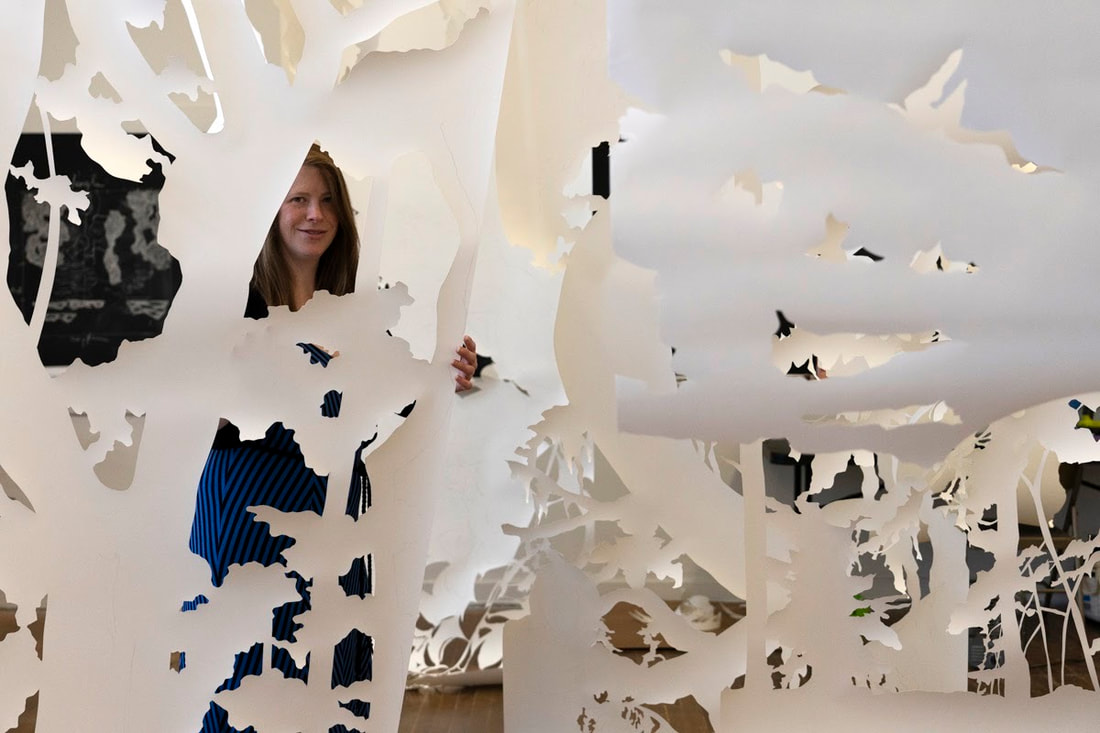 Erin Oliver working on her paper installation at Goldenbelt Arts